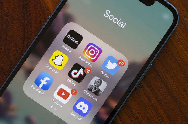 A phone's screen showing the icons for different social media apps.