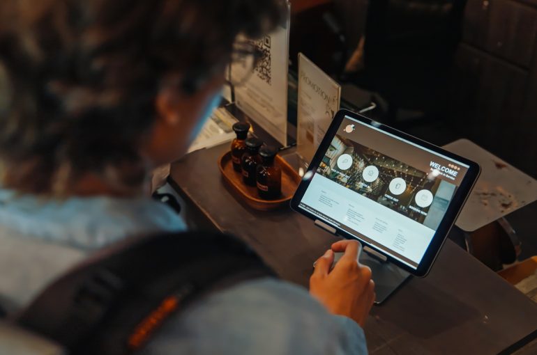 Friends Using Self Check-In on tablet at Hostel